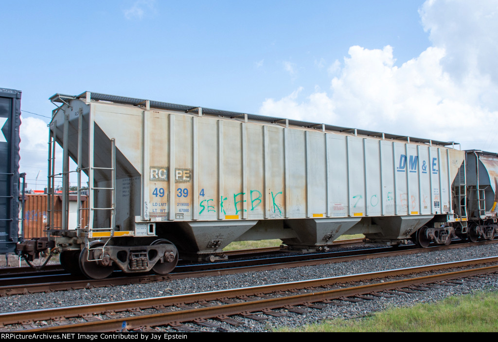 A DM&E Hopper trails on eastbound KCS Train 